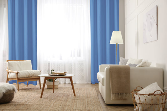 cortin azul en sala de estar iluminada, silla y mesa de centro