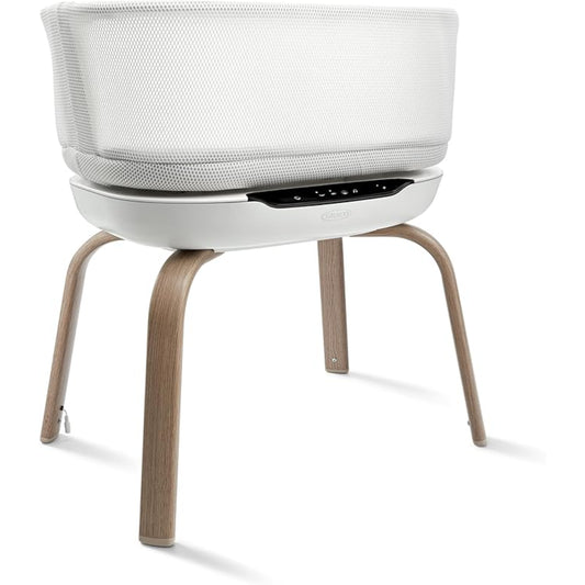 Moises Graco blanco con patas de madera, ideal para bebés en el dormitorio