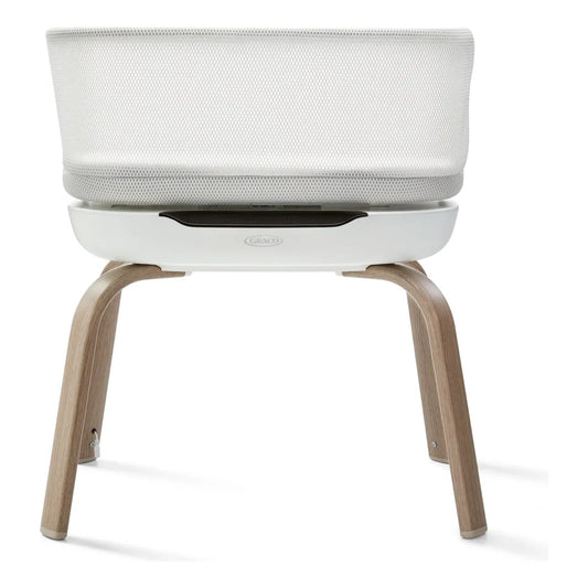 Moises Graco blanco con patas de madera, vista trasera, ideal para el dormitorio