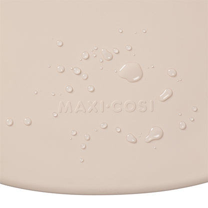 Cambiador beige de MAXI COSI con textura y gotas de agua visible