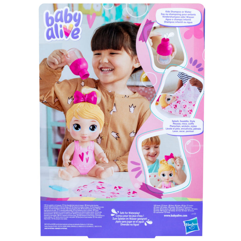 Muñeca Baby Alive con cabello rubio y vestido rosa, niña jugando con ella
