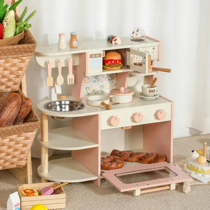 cocina de juguete rosa con accesorios y microondas en el comedor