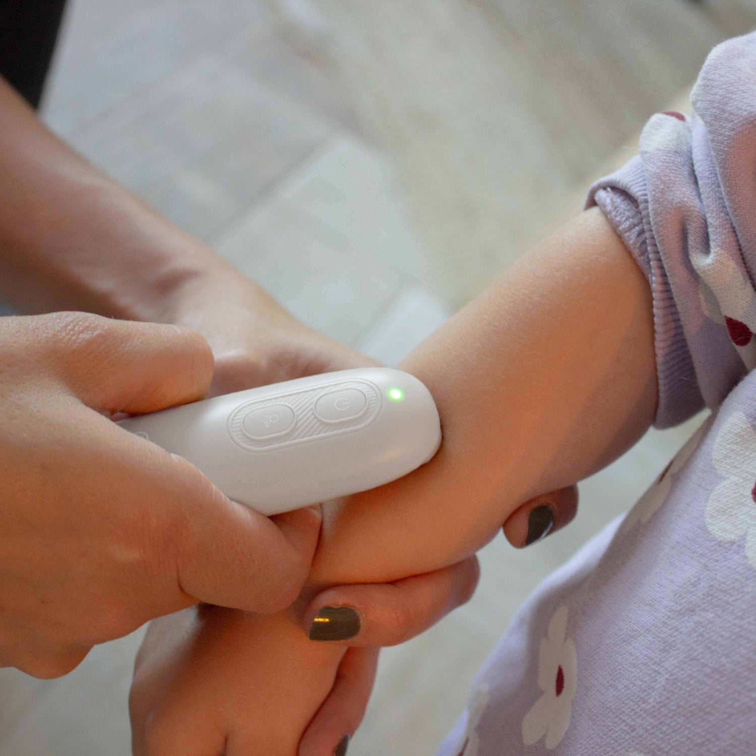 Dispositivo Curador blanco en brazo de niño, uso médico en casa