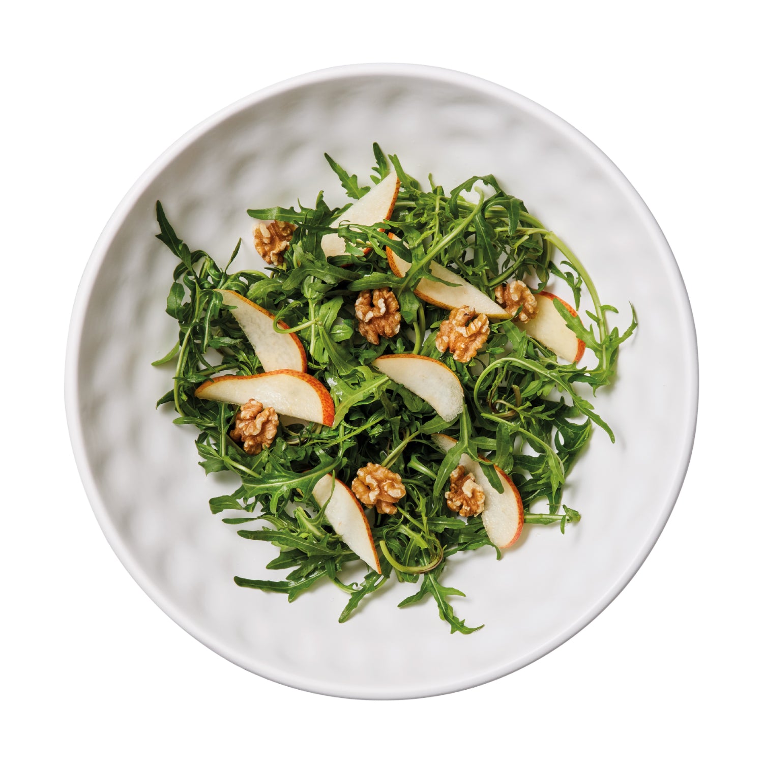 ensaladera blanca con ensalada de arúgula, manzana y nueces vista superior