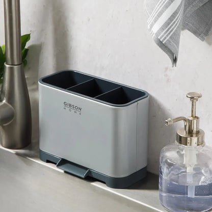 Organizador de utensilios gris en lavamanos, práctico y moderno para cocina