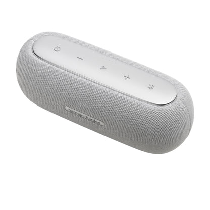 Parlante HARMAN KARDON gris, vista lateral, diseño elegante y moderno