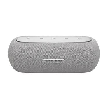 Parlante gris Harman Kardon, vista frontal sobre mesa