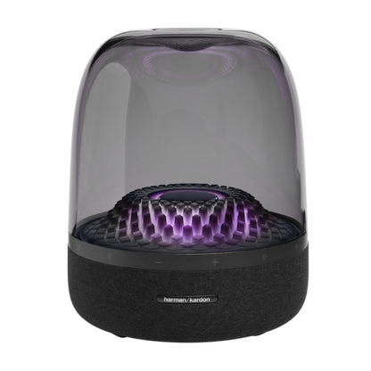 Parlante Harman Kardon transparente, vista frontal con luces LED moradas.