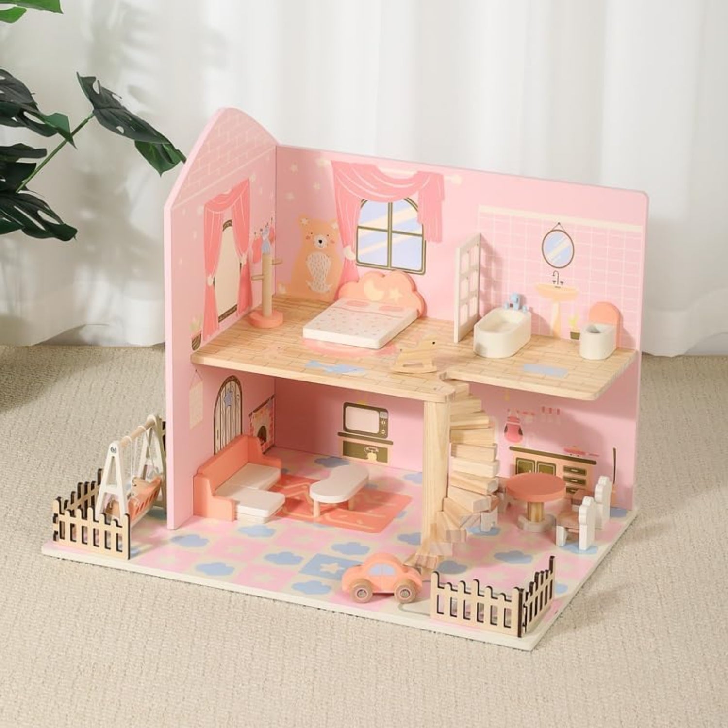 Casa de muñecas rosa con muebles de madera, vista interior en sala de estar