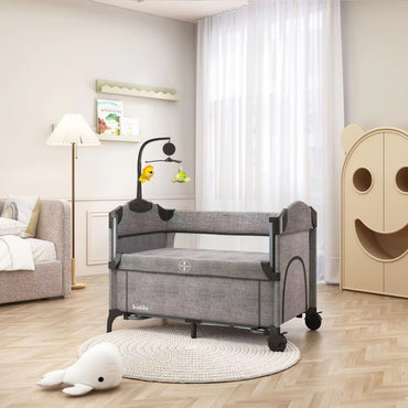 Cuna portátil gris KIDILO vista lateral en habitación infantil