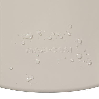 Cambiador beige de MAXI COSI, vista detallada con gotas de agua