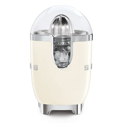 Exprimidor SMEG color crema, frontal, con diseño retro y tapa transparente