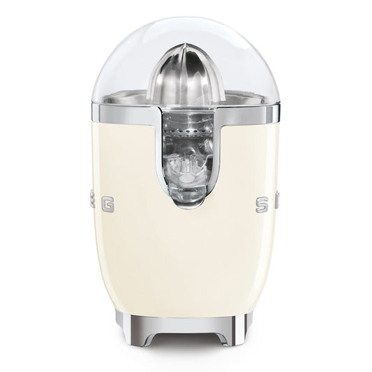 Exprimidor SMEG color crema, frontal, con diseño retro y tapa transparente