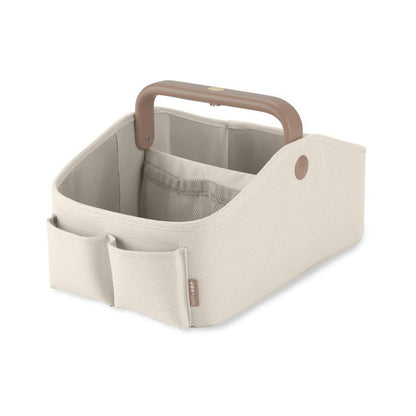 Cesta organizadora SKIP*HOP beige, vista lateral, ideal para almacenar juguetes.