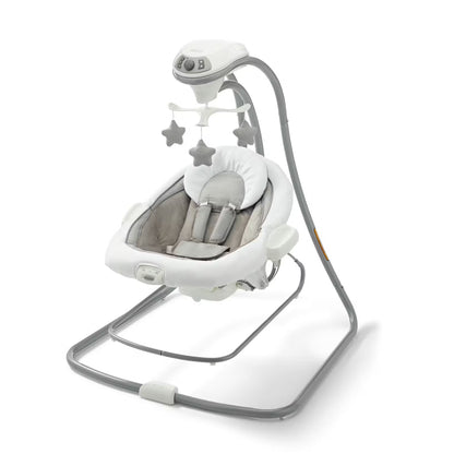 Silla mecedora Graco blanca con móvil de estrellas, vista frontal